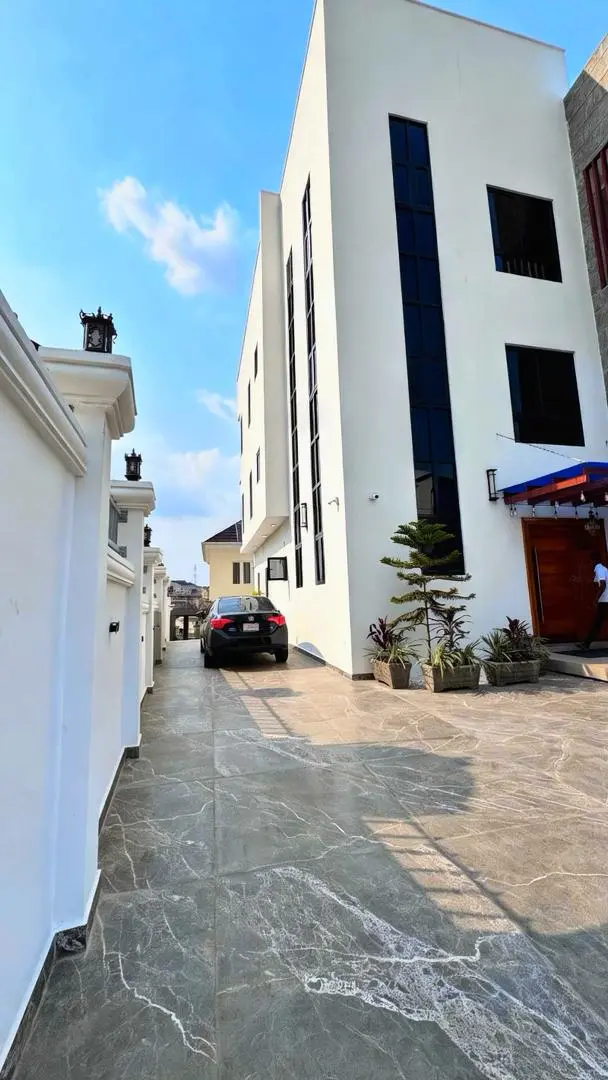 Completed side exterior and paved access at BJ Apartment